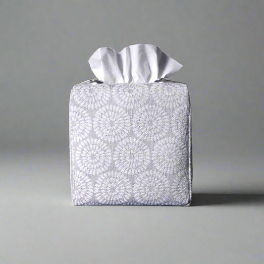 Square tissue box cover with white retro daisy design on light grey background