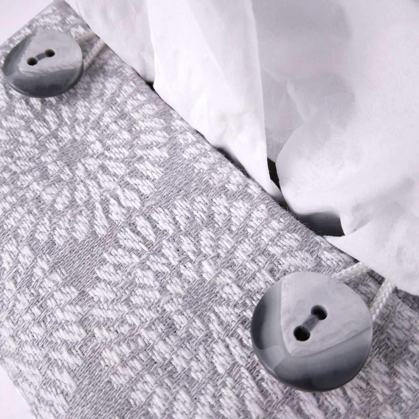 Close up view of square tissue box cover with buttons