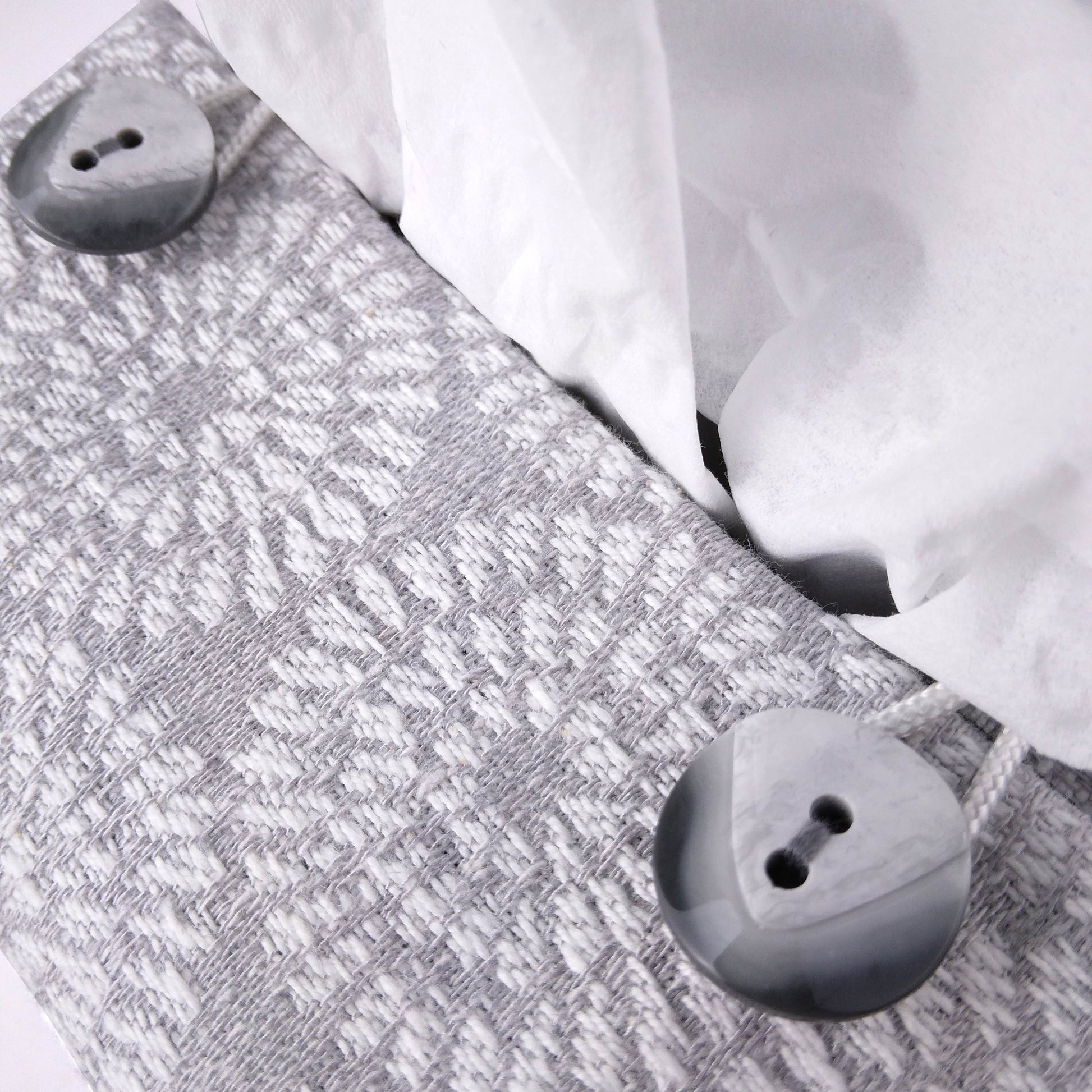 Close up view of square tissue box cover with buttons