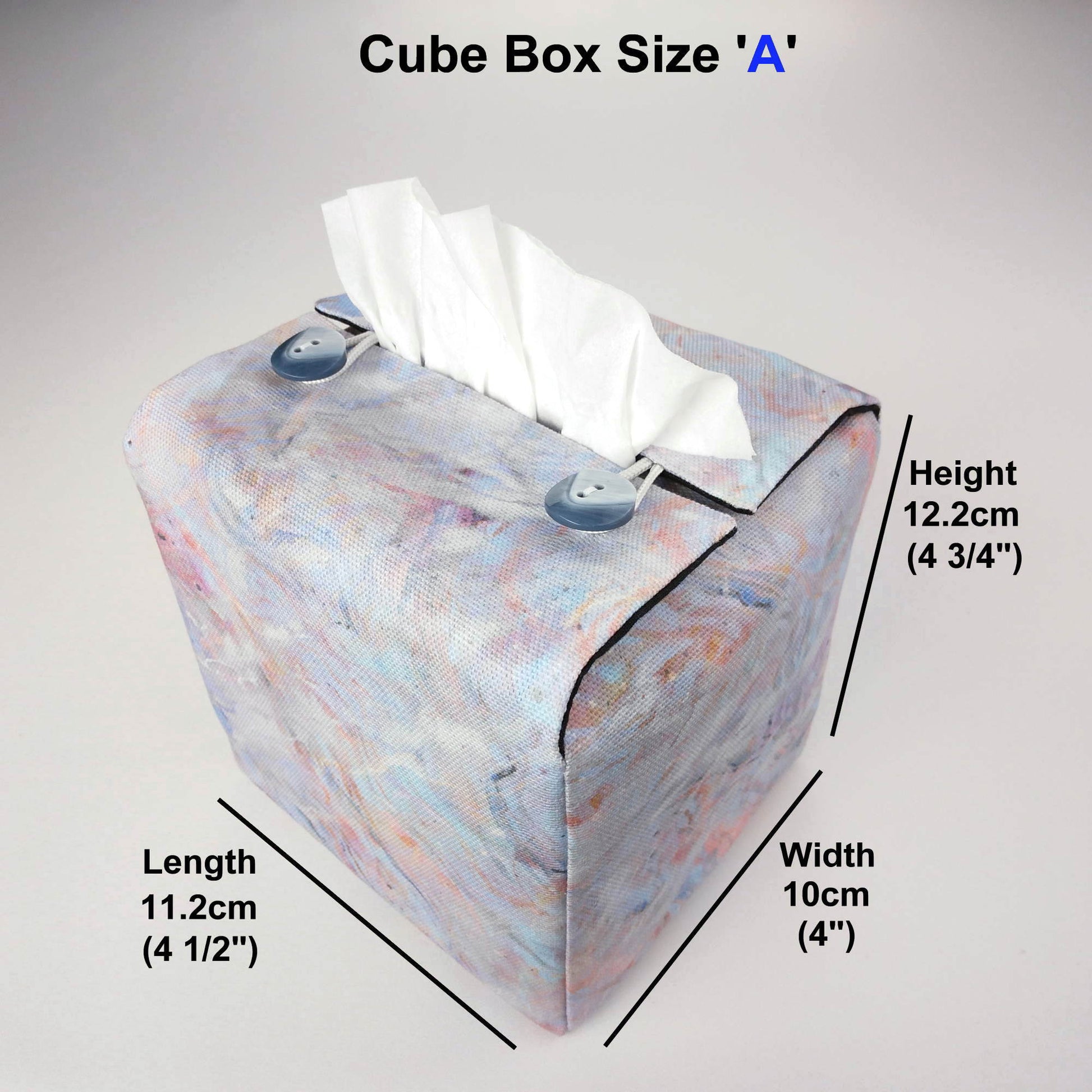 Square tissue box cover with white, orange, pink, blue and grey abstract pattern