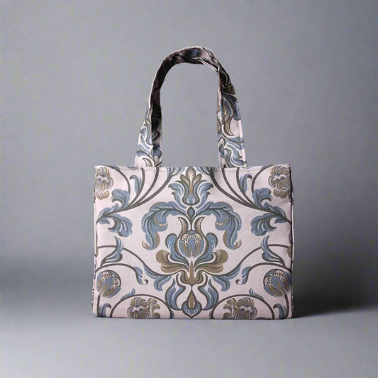 Mini tote bag with grey and brown baroque style floral design on taupe background