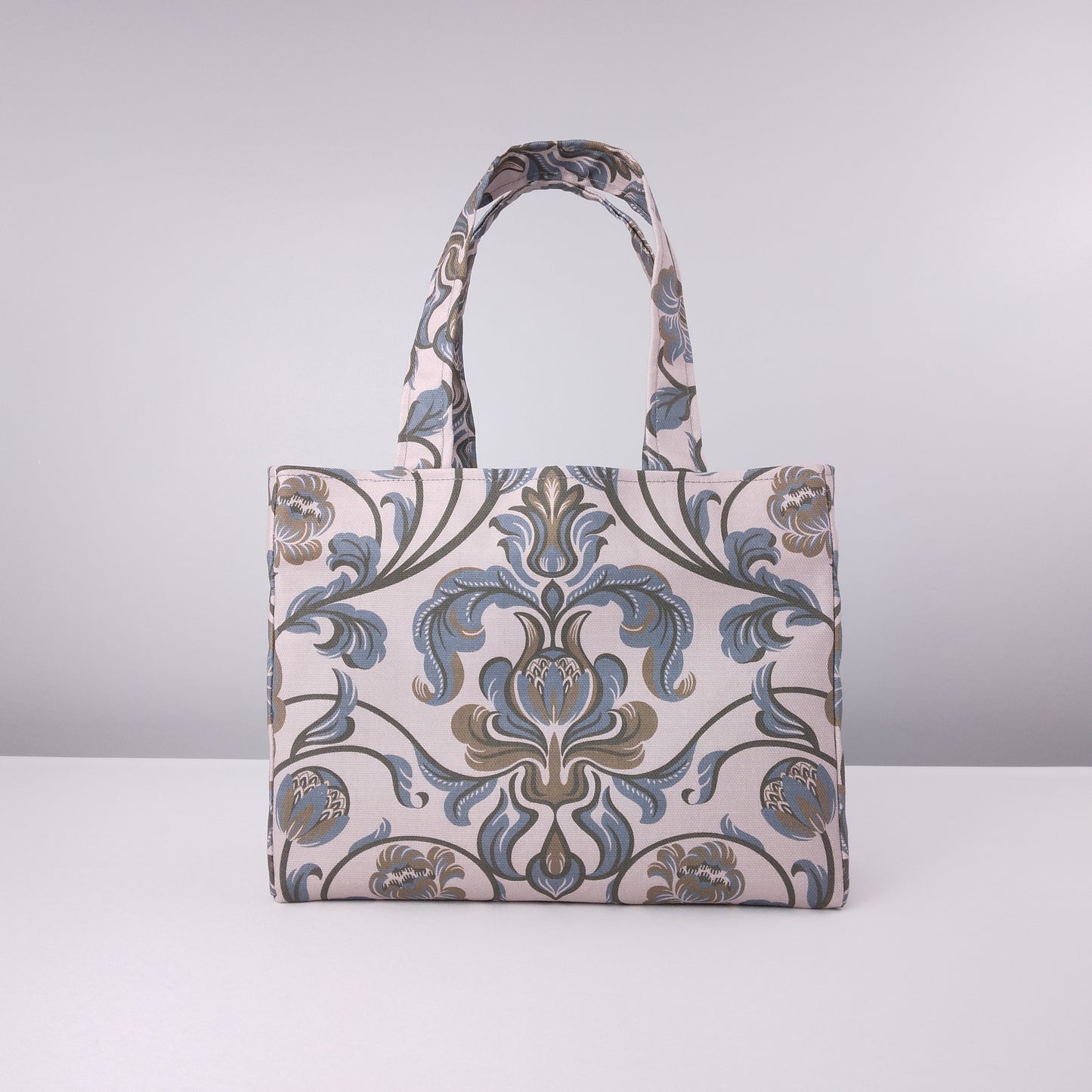 Mini tote bag with grey and brown baroque style floral design on taupe background
