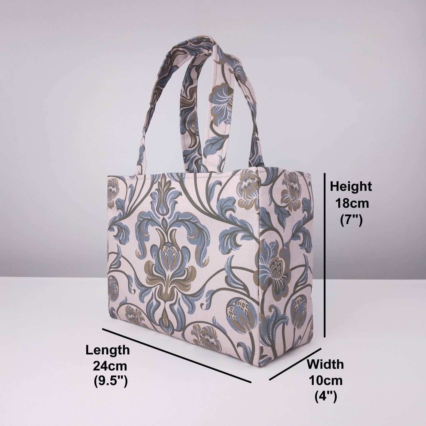 Mini tote bag with grey and brown baroque style floral design on taupe background