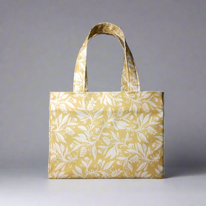 Mini tote bag with white wildflower silhouette design on yellow background