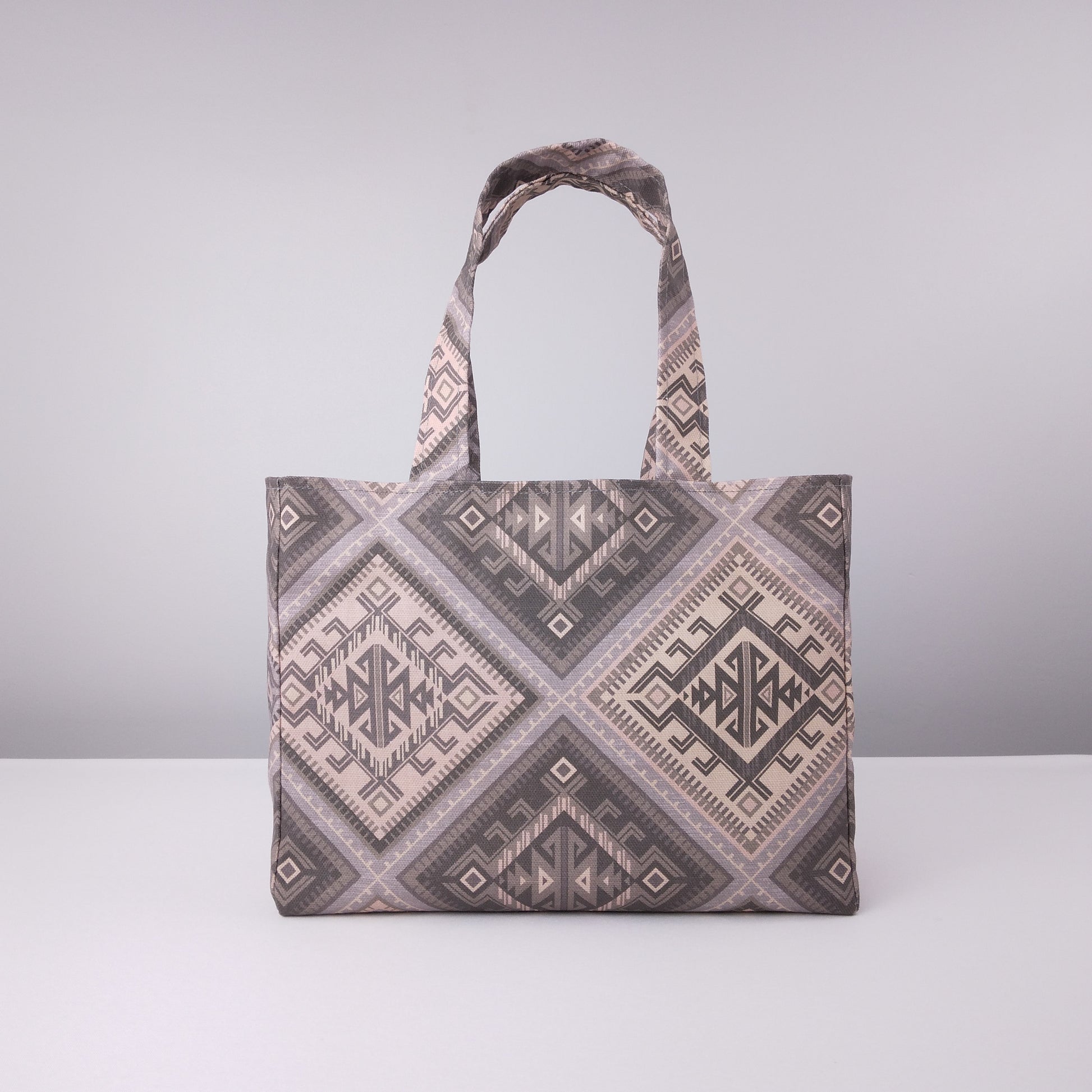 Front view of a mini tote bag with grey diamond kilim pattern