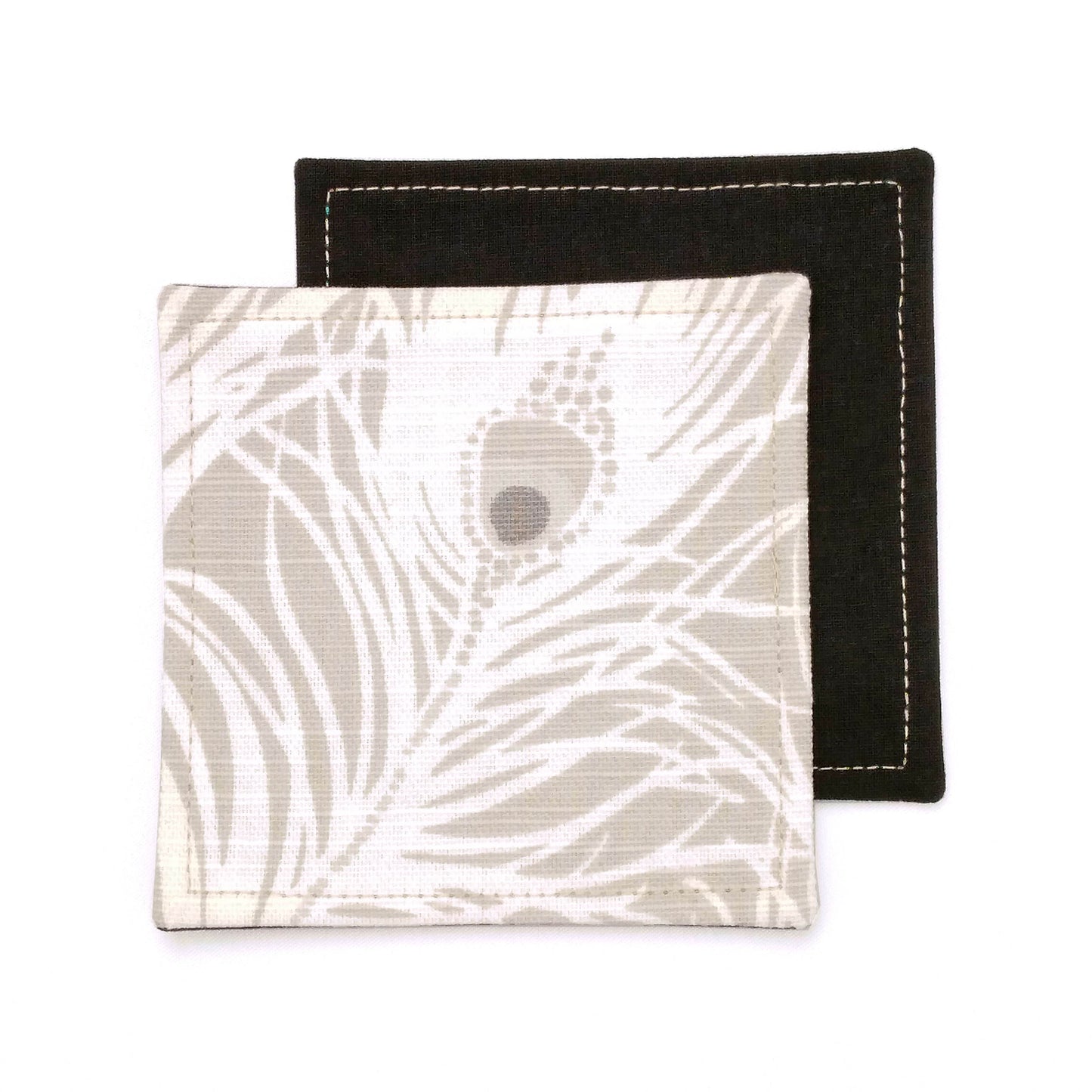 Square coasters with white peacock feathers design on natural colour background