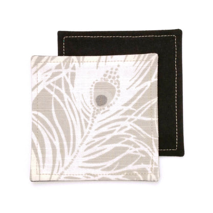 Square coasters with white peacock feathers design on natural colour background