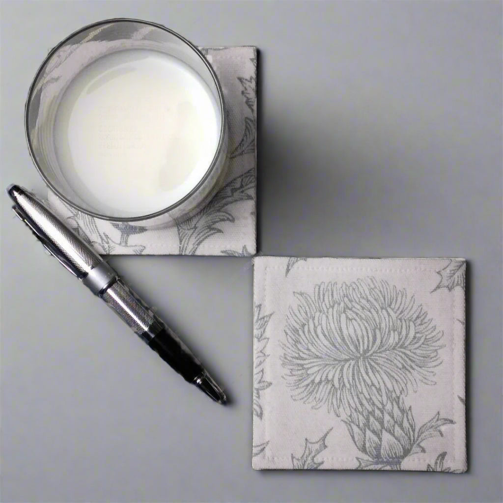 Square coasters with grey thistle design on white background