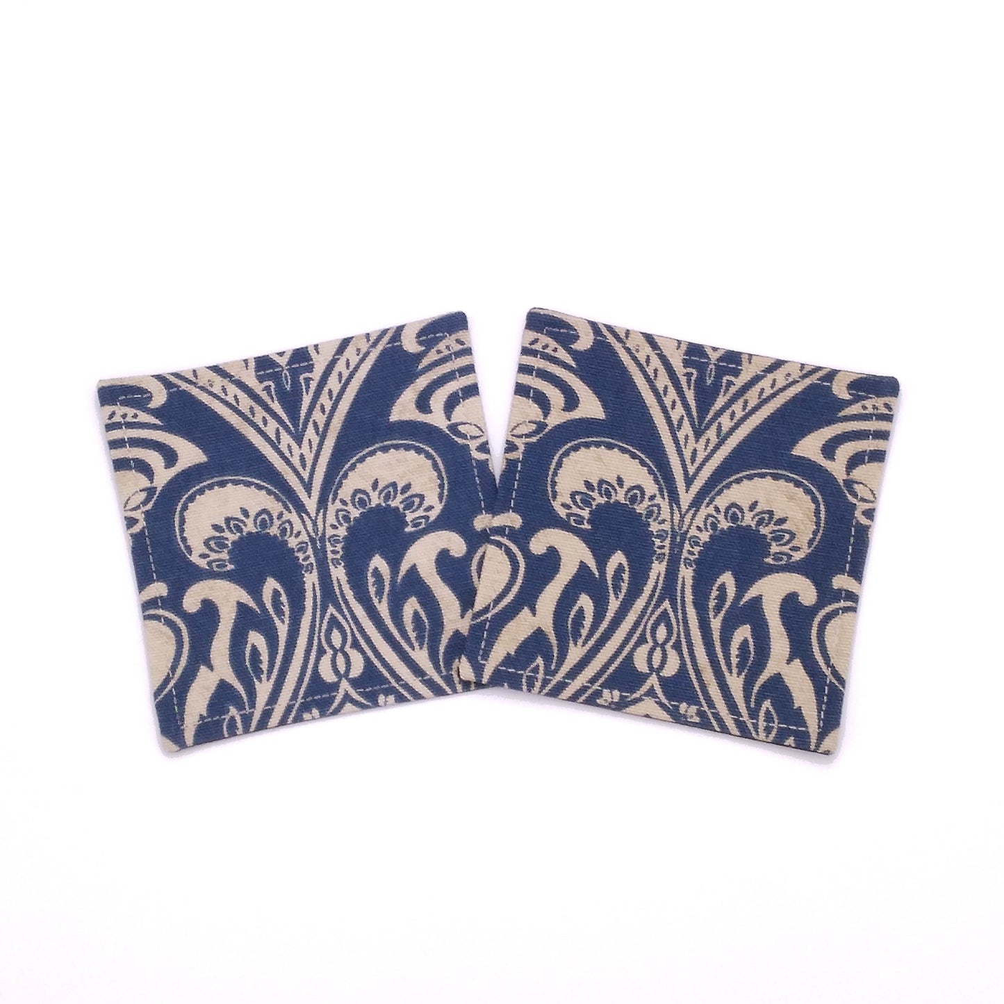 Square coasters with tan damask print on blue background