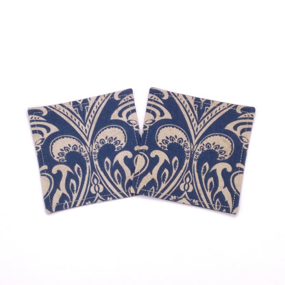 Square coasters with tan damask print on blue background