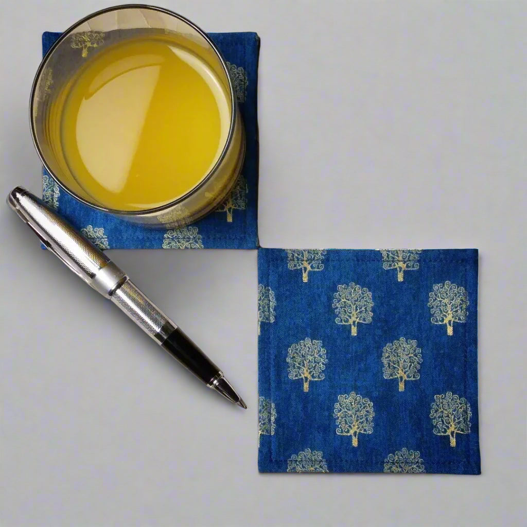 Square coasters with gold colour trees design on blue background