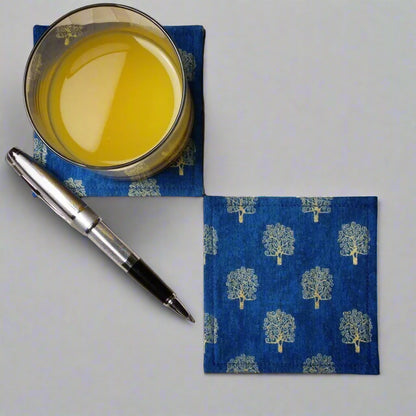 Square coasters with gold colour trees design on blue background