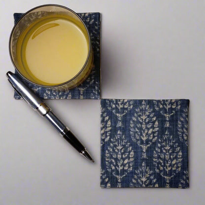Square coasters with tan poplar trees design on blue background