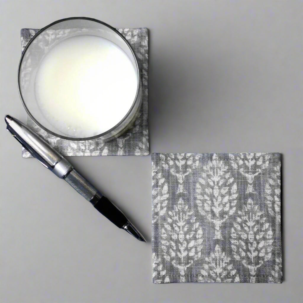 Square coasters with off white poplar trees design on grey background