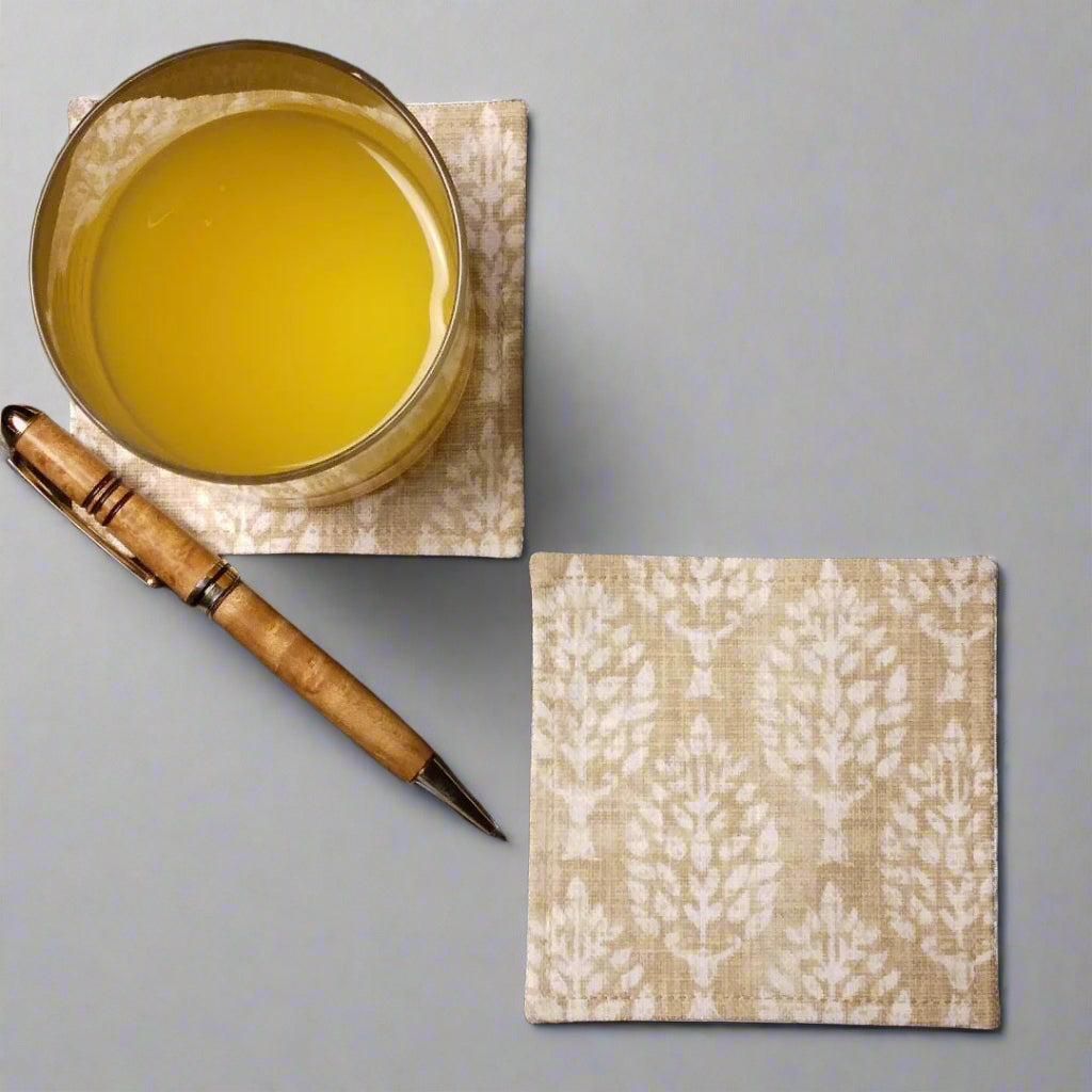 Square coasters with tan poplar trees design on wheat colour background