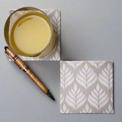 Square coasters with off-white leaf icon design on natural colour background