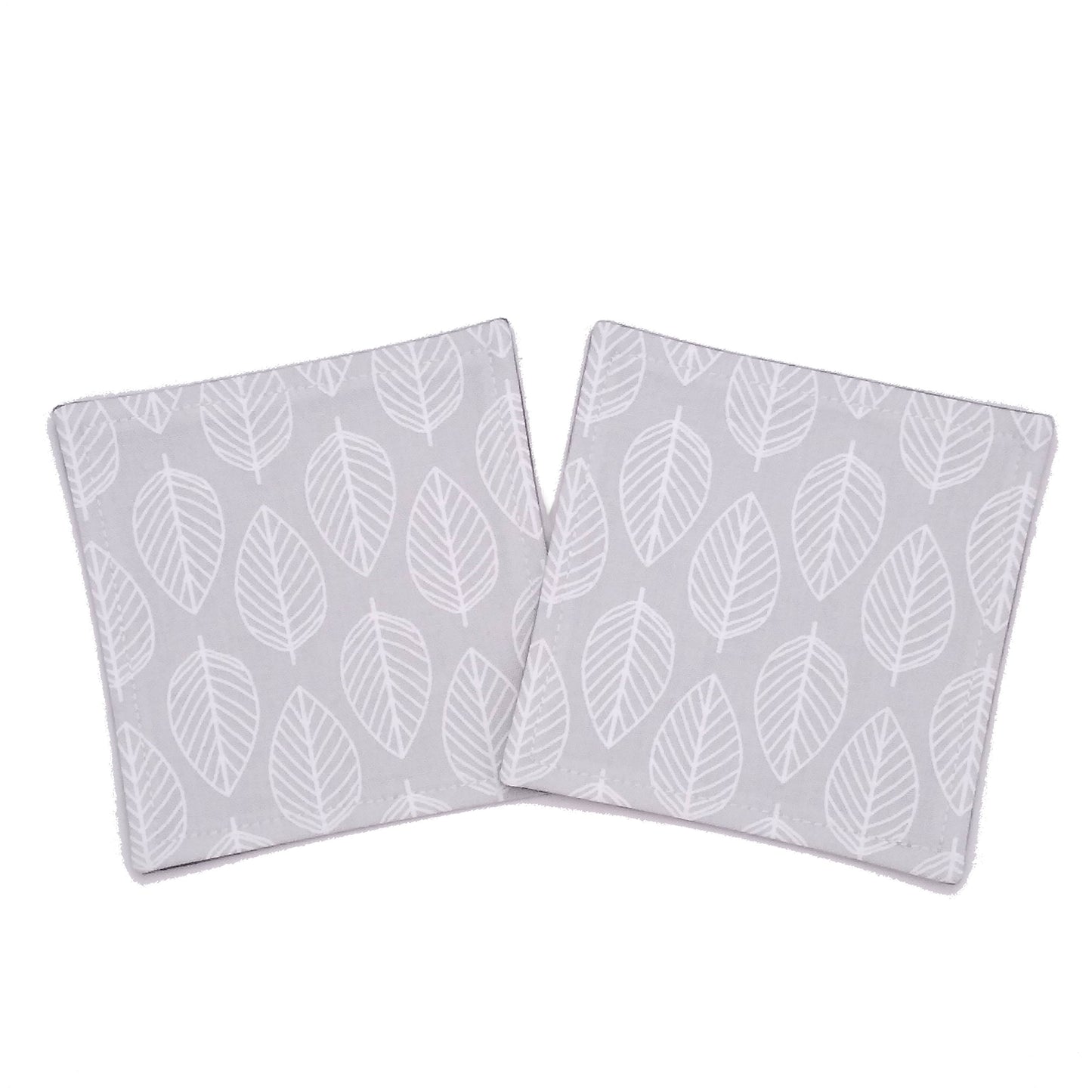 Square coasters with white leaf outline on grey background