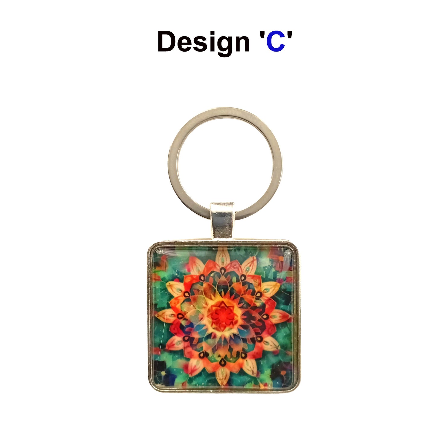 Square glass cabochon with multi colour mandala design set in a metal frame with stainless steel keyring