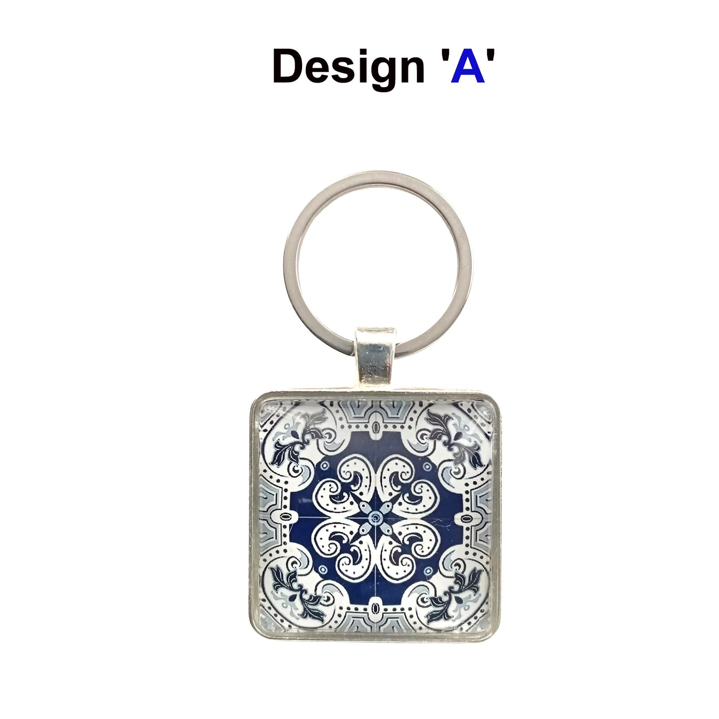 A keyring with blue and white tile design cabochon in a metal setting with split ring