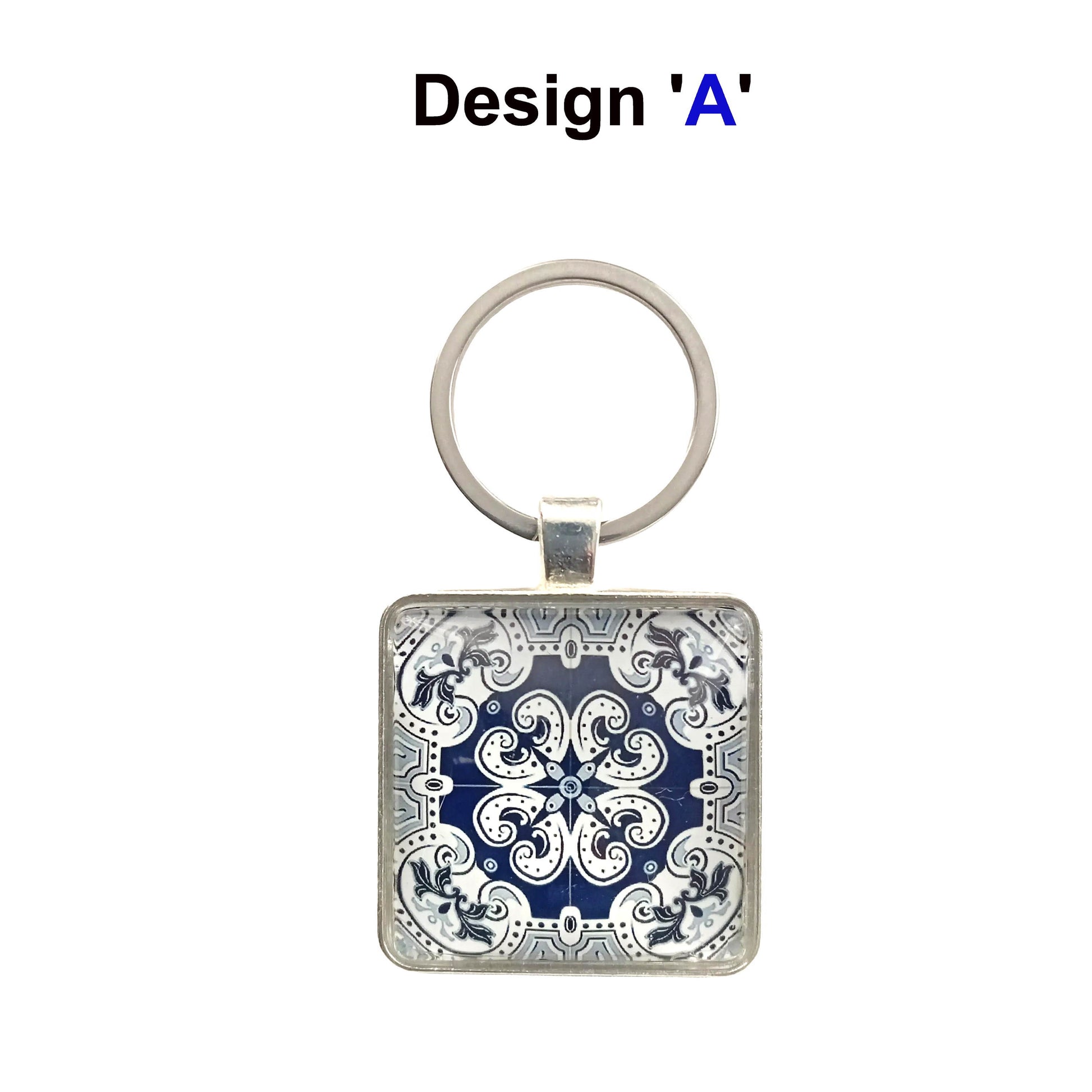 A keyring with blue and white tile design cabochon in a metal setting with split ring