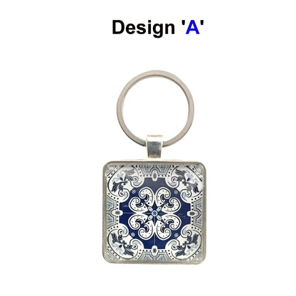 A keyring with blue and white tile design cabochon in a metal setting with split ring