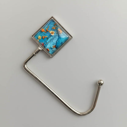 Glass cabochon purse hook with colourful floral collage image and metal hook