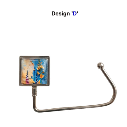 Handbag hook with glass cabochon and colourful yellow and blue floral collage image, and metal hook
