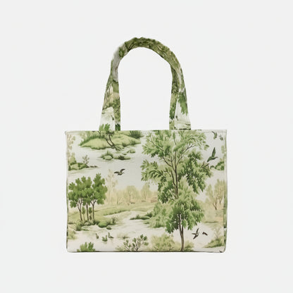 The opposite side of a handmade mini cotton tote bag with a green and white toile-style landscape print featuring trees, birds, and a river, shown against a neutral white background.