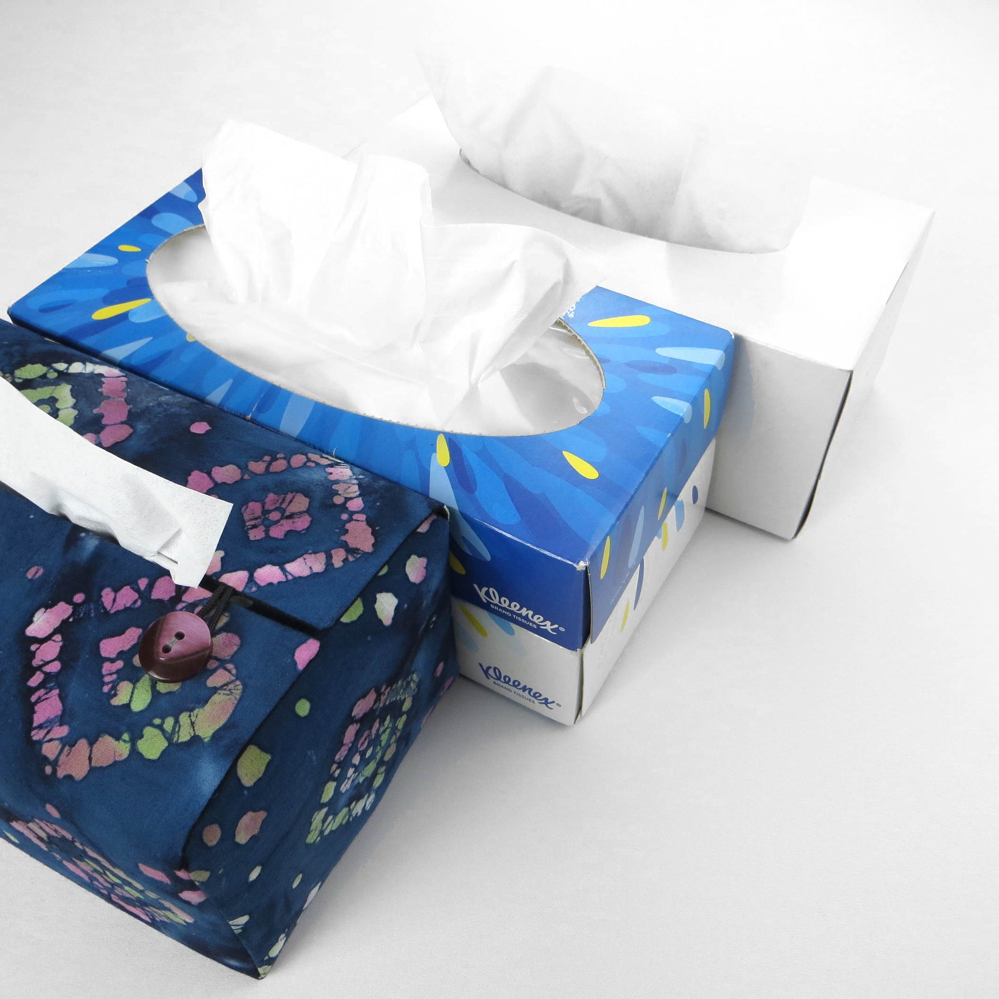 Batik printed cotton rectangle tissue box cover with tie dye magenta and green diamond design on blue background