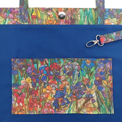 A handmade large cotton tote bag interior with a colourful floral print on the handles and matching slip pockets, featuring a metal key clip.