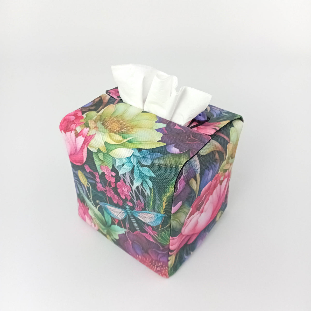 The reverse view of a handmade square cotton tissue box cover with a vibrant multicolour floral and dragonfly pattern.