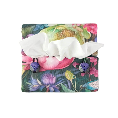Top view of a handmade square cotton tissue box cover with a colourful floral and dragonfly print. The cover has two purple button closures.