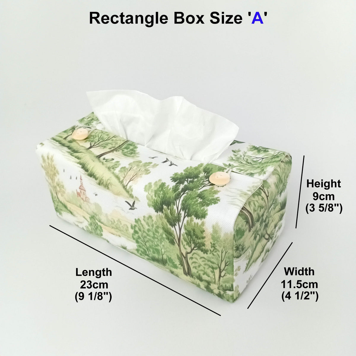 A handmade rectangular cotton tissue box cover with a green and beige woodland landscape print on an off-white  background, and product measurements.