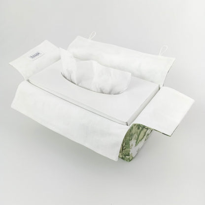 Interior view of a handmade cotton tissue box cover with a white interior and a green botanical pattern exterior.