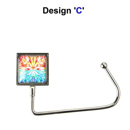 Handbag hook with a glass domed blue and orange abtract image