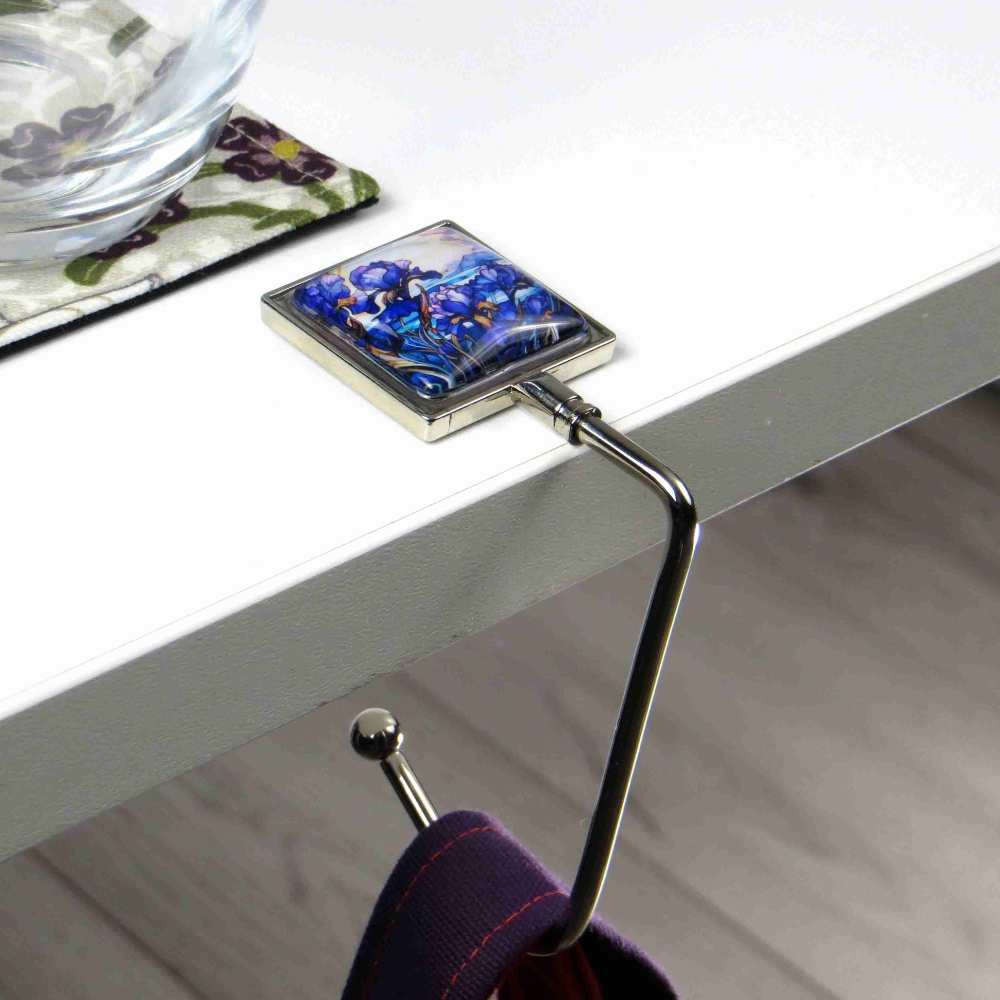 Handbag hook with glass domed image for hanging accessories on tables, ledges, and shelves