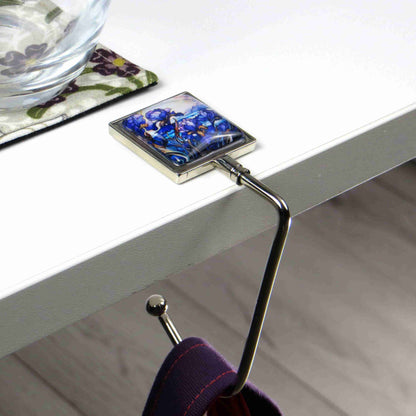 Handbag hook with glass domed image for hanging accessories on tables, ledges, and shelves