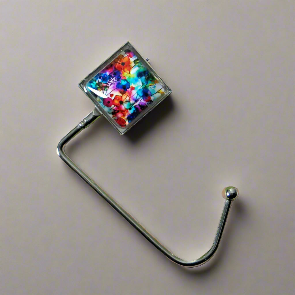 Handbag hook with glass domed image for hanging accessories on tables, ledges, and shelves