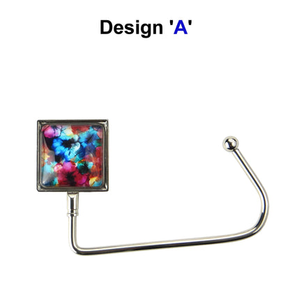 Handbag hook with glass domed image for hanging accessories on tables, ledges, and shelves
