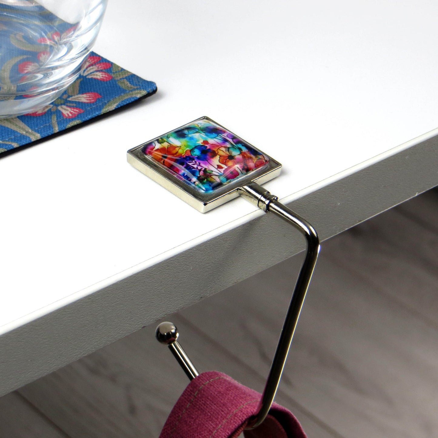 Handbag hook with glass domed image for hanging accessories on tables, ledges, and shelves