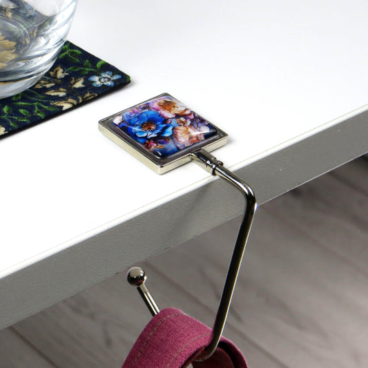 Handbag hook with glass domed image for hanging accessories on tables, ledges, and shelves