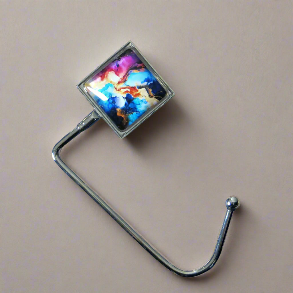 Handbag hook with glass domed image for hanging accessories on tables, ledges, and shelves