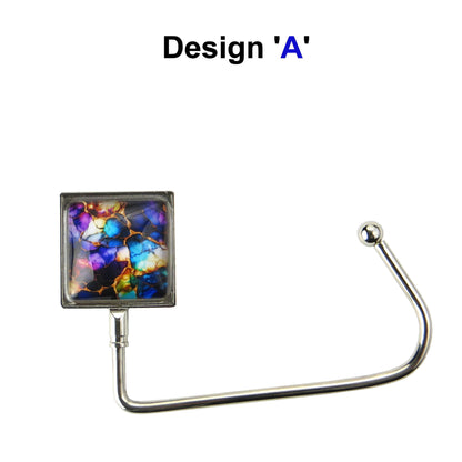 Handbag hook with glass domed image for hanging accessories on tables, ledges, and shelves