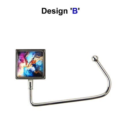 Handbag hook with glass domed image for hanging accessories on tables, ledges, and shelves