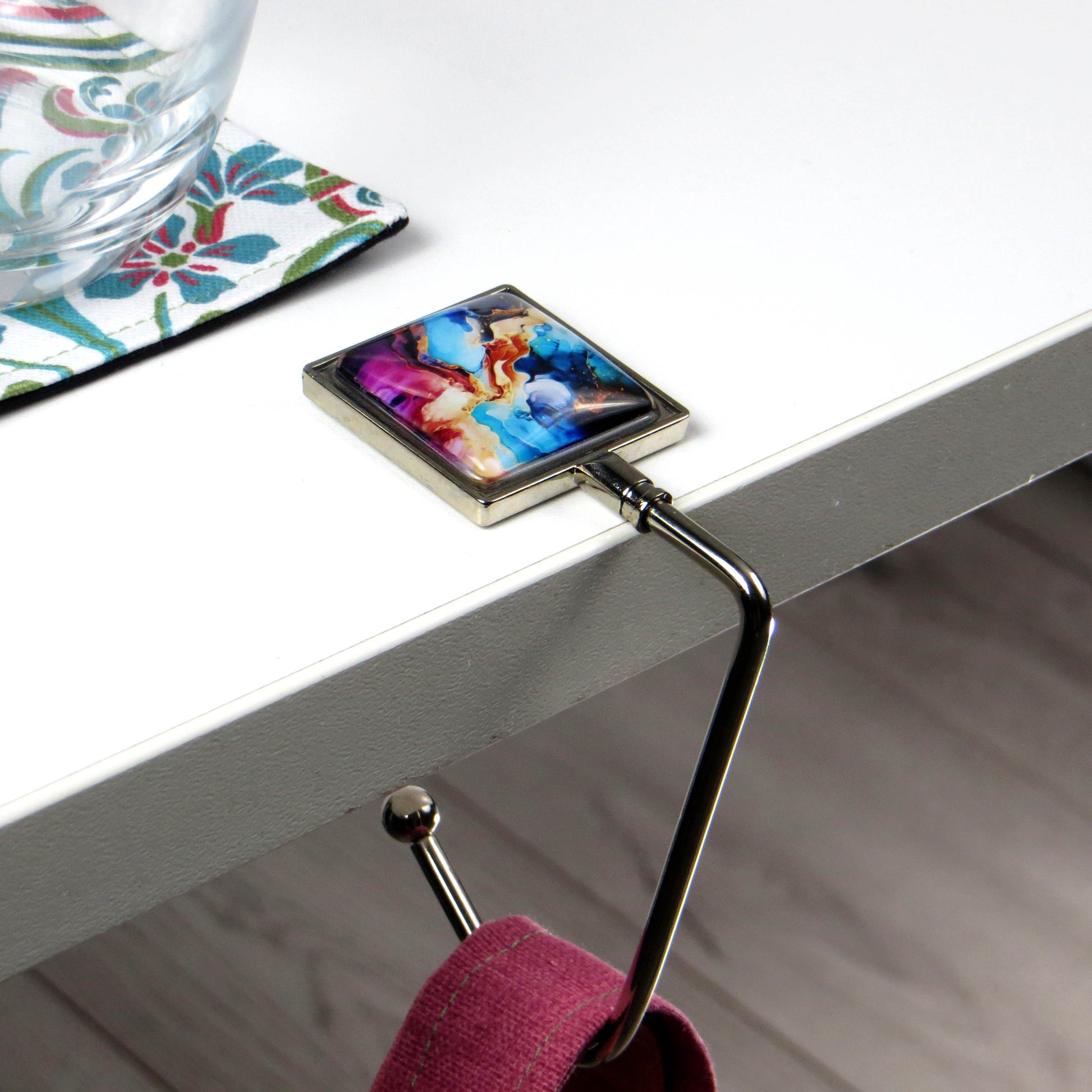 Handbag hook with glass domed image for hanging accessories on tables, ledges, and shelves