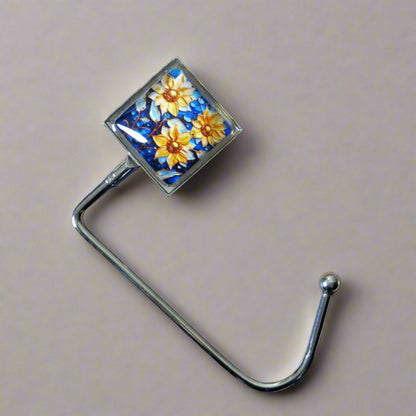 Handbag hook with glass domed image for hanging accessories on tables, ledges, and shelves