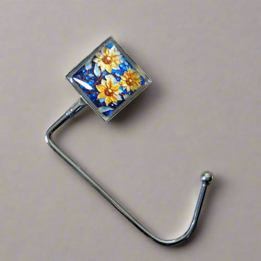 Handbag hook with glass domed image for hanging accessories on tables, ledges, and shelves