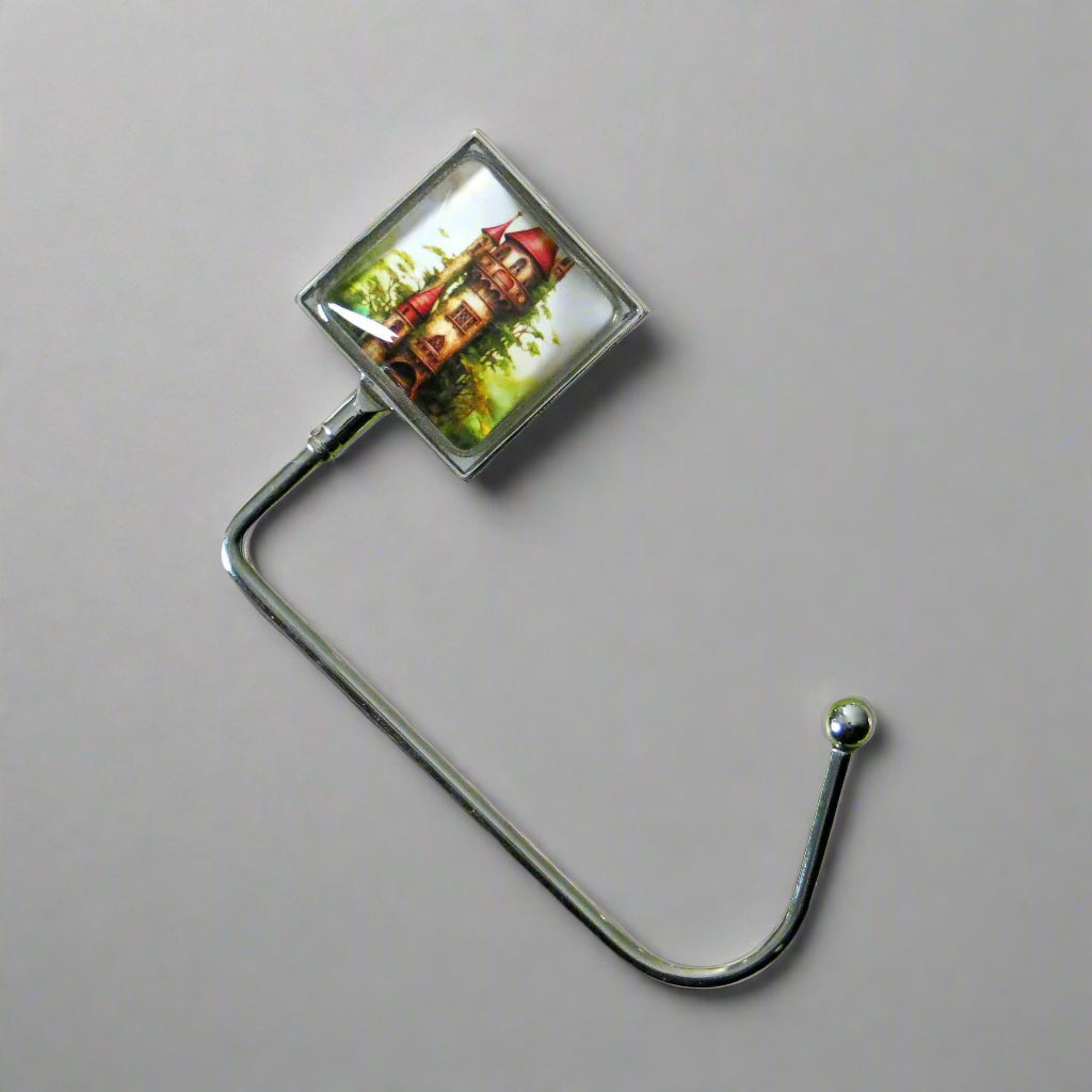Handbag hook with glass domed image for hanging accessories on tables, ledges, and shelves