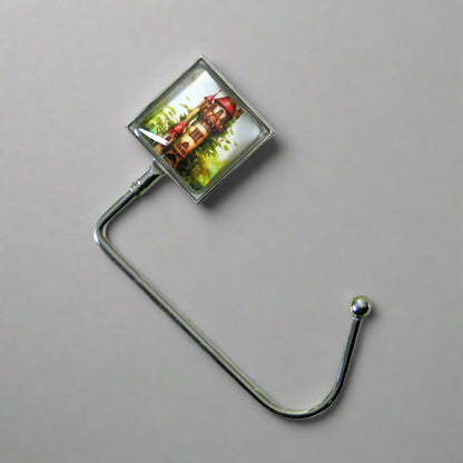 Handbag hook with glass domed image for hanging accessories on tables, ledges, and shelves
