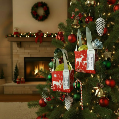 Small tote bag style Christmas decorations filled with treats hanging on a Christmas tree